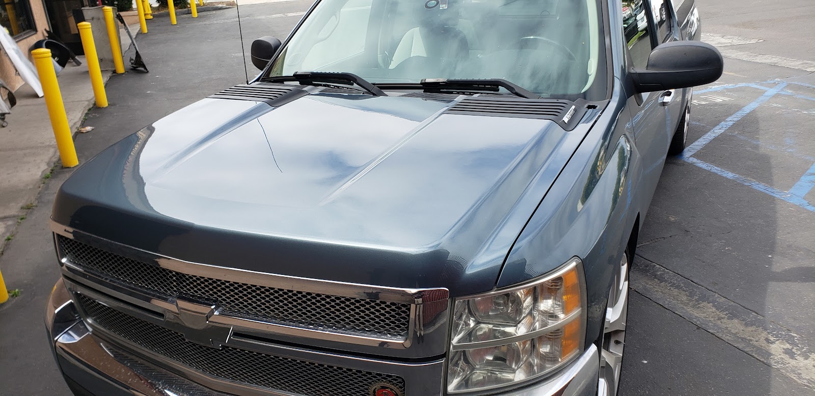 Dark gray Chevrolet Silverado pickup with a freshly painted hood